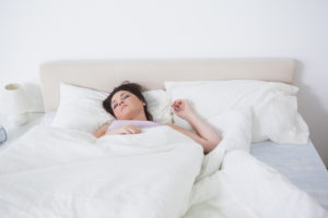 woman sleeping on back in bed