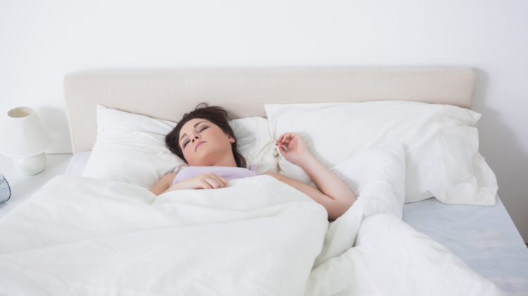 woman sleeping on back in bed