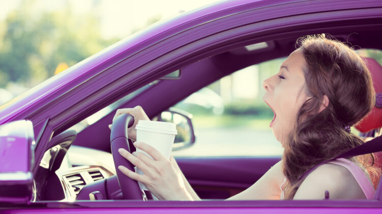 woman yawning while driving